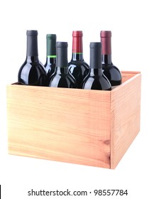 An Assortment Of Red Wine Bottles Standing In A Wooden Crate Isolated On A White Background.