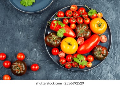 Assortment of ripe tomatoes varieties. Platter of colorful tomatoes and cherry tomatoes.