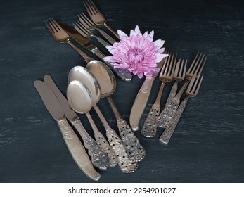 An assortment of silver spoons, knives, and forks on a table. - Shutterstock ID 2254901027