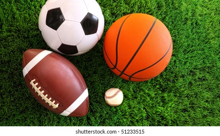 Assortment of sport balls on green grass