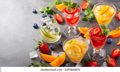 Assortment summer non-alcoholic cocktails with fresh berries, herbs and fruits on dark background. - Shutterstock ID 1395863870
