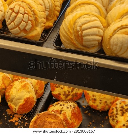 Assortment of sweet bread on service counter in local business.Surtido de pan dulce sobre mostrador de servicio en negocio local
