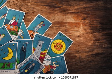 Assortment Of Tarot Inspired Cards On A Wooden Background