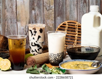 Assortment of tea with Grass Jelly tea, Black, Lemon Powder Balls, Brown sugar milk bubble, winter melon, Green, served in disposable cup isolated on table side view taiwan style - Shutterstock ID 2228658721