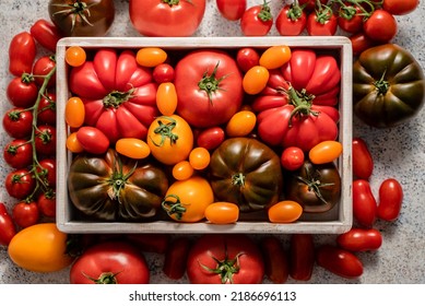 Assortment of tomatoes in a wooden box - Powered by Shutterstock