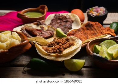 Assortment of traditional mexican tacos on wooden background