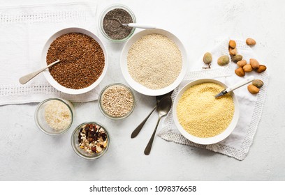 Assortment Uncooked Cereals, Grains, Seeds Pasta For Breakfast Porridge Cooking In Bowl Marble Table, Overhead Close-up. Breakfast Porridge Bowl Vegan, Vegetarian Balanced Dieting Food Concept