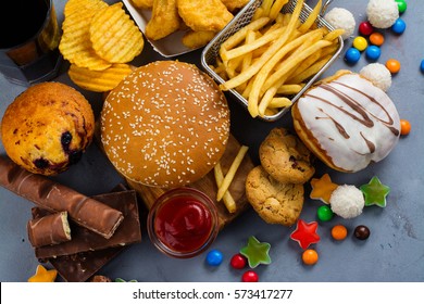 Assortment of unhealthy products that's bad for figure, skin, heart and teeth. Fast carbohydrates food. Space for text - Shutterstock ID 573417277