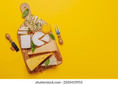 An assortment of various cheeses arranged on a board, highlighting different textures, colours, and types, perfect for a tasting or appetizer - Powered by Shutterstock