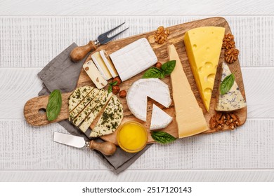 An assortment of various cheeses arranged on a board, highlighting different textures, colours, and types, perfect for a tasting or appetizer - Powered by Shutterstock