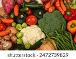 Assortment of vegetables with carrots, green beans mushrooms, bell peppers, butternut, cauliflower, Brussels sprouts, zucchini, broccoli, tomatoes, squash, garlic and ginger.