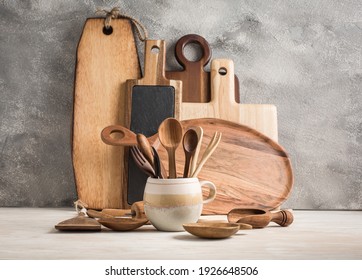 Assortment of wooden cutting boards and kitchen utensils on wooden background - Powered by Shutterstock