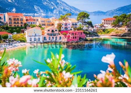 Assos, Greece. Picturesque village nestled on the idyllic Cephalonia, Ionian islands. Beautiful colorful houses and turquoise colored bay.