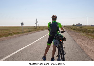 Astana Kazakhstan Dec 23 2021: Bicycle Tourist Looking Forward, Standing On An Empty Road