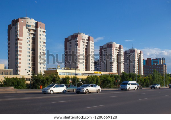 ASTANA, KAZAKHSTAN - JULY 25, 2017: View of the\
modern residential buildings near road in the dormitory area of\
Astana city. Astana is the capital city of Kazakhstan and the\
second-largest city.