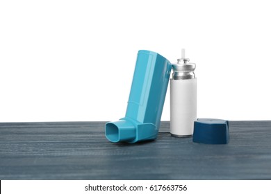 Asthma Inhaler On Wooden Table