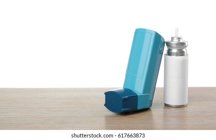 Asthma Inhaler On Wooden Table