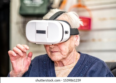 Astonished face of a elderly retired woman on the wheelchair using VR glasses. Virtual reality experience. - Powered by Shutterstock