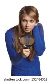 Astonished girl looking through the magnifying glass downwards, over white background