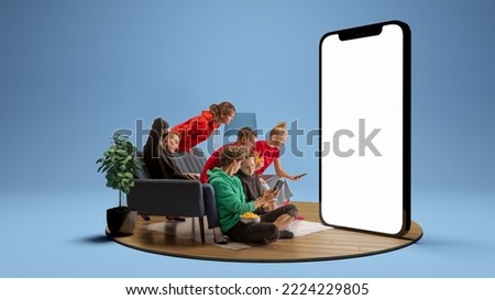 Astonished young people, emotional friends watching football match, sport show and betting. Youth sitting on sofa in front of huge 3D model of empty phone screen. Concept of sport, leisure activities