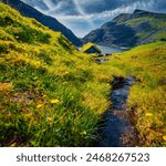 Astonishing summer scene of Saksun village with typical turf-top houses and pure water brook. Sunny morning view of Streymoy island, Faroe, Denmark, Europe. Traveling concept background.