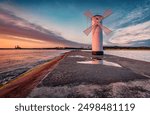 Astonishing summer view of Stawa windmill. Breathtaking sunrise on Szczecin Lagoon. Nice morning seascape of Baltic Sea, Swinoujscie, Western Pomerania, Poland, Europe. Traveling concept background.