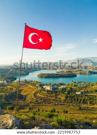 An astonishing view of the Green Lake with beautiful nature around and the mountains in the background in the Manavgat region of Turkey. The Turkish flag up in the air. High quality photo