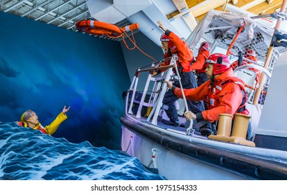Astoria, Oregon U.S.A. - April 15, 2021: At the Maritime Museum, a display showcased a Coast Guard rescue at sea - a red life preserver ring being thrown into the waves to a drowning man 