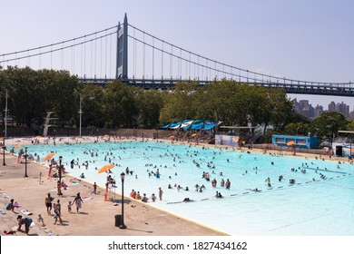 Astoria Queens, New York / USA - August 25 2020: Astoria Pool At Astoria Park During The Summer With People And The Triborough Bridge In The Background