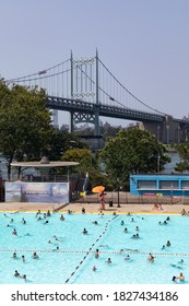 Astoria Queens, New York / USA - August 25 2020: Astoria Pool At Astoria Park During The Summer With People And The Triborough Bridge In The Background