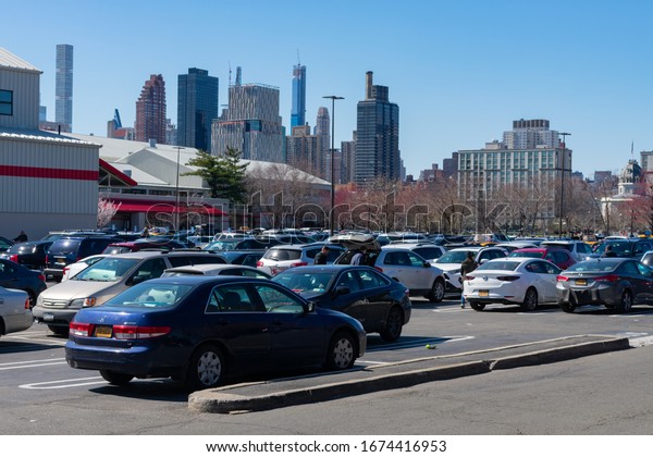 Astoria Queens, New York / USA - March 15 2020:\
Parking Lot filled with Cars and Panicked Shoppers at the Costco\
Wholesale Store in Astoria Queens of New York City during the\
Coronavirus Outbreak