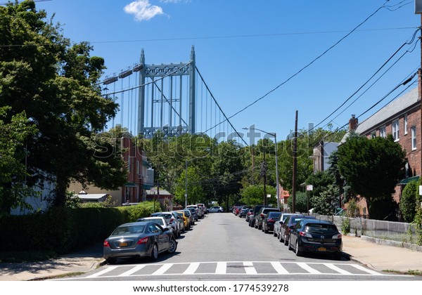 Astoria Queens, New York / USA - June 13 2020:\
Neighborhood Street in Astoria Queens New York with the Triborough\
Bridge
