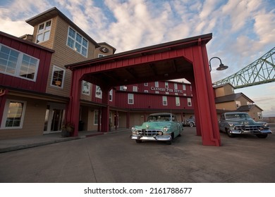 Astoria, OR - September 26, 2011: Vintage cars parked outside the luxury Cannery Pier Hotel next to the Astoria-Megler bridge.