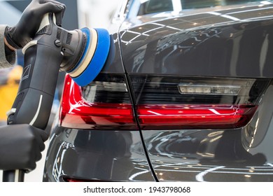 Astrakhan, Russia 25 March 2021: specialist polishes car BMW body polishing