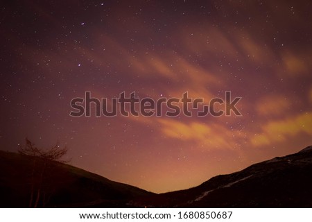 astral starry night sky with valley silhouette 