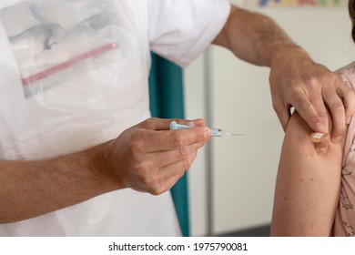 The Astrazeneca Vaccine Against Covid-19 Is Injected In To A Woman’s Arm By A Doctor At A UK GP Surgery