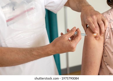 The Astrazeneca Vaccine Against Covid-19 Is Injected In To A Woman’s Arm By A Doctor At A UK GP Surgery