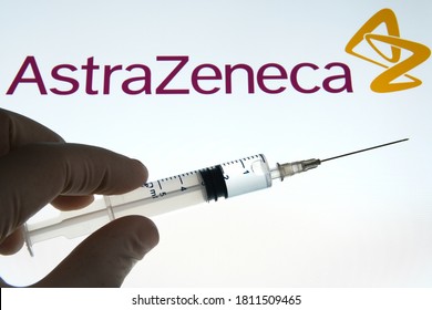 AstraZeneca vaccine also known as Oxford COVID vaccine. Hand holding a syringe and AstraZeneca logo on the blurred background. Concept. Stone, UK - September 9 2020.