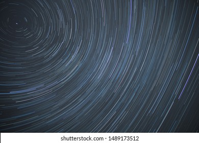 Astro photography time lapse of star trails rotating around the north polar star showing the rotation of earth