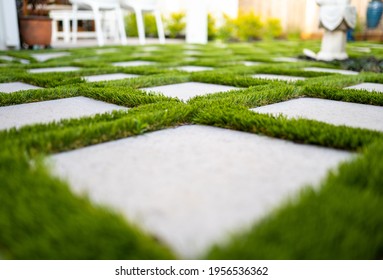 astro turf between concrete pavers  - Shutterstock ID 1956536362