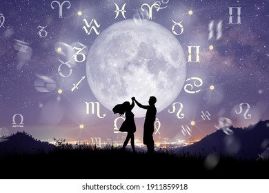 Astrological zodiac signs inside of horoscope circle. Couple singing and dancing over the zodiac wheel and milky way background. The power of the universe concept.