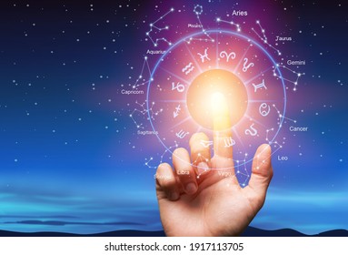 Astrological zodiac signs inside of horoscope circle with human hand - Powered by Shutterstock