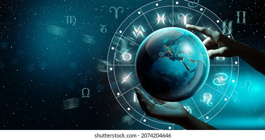 Astrological zodiac signs inside of horoscope with planet Earth in hand. Knowledge of the stars in the sky. The power of the universe concept. Elements furnished by NASA. - Shutterstock ID 2074204646