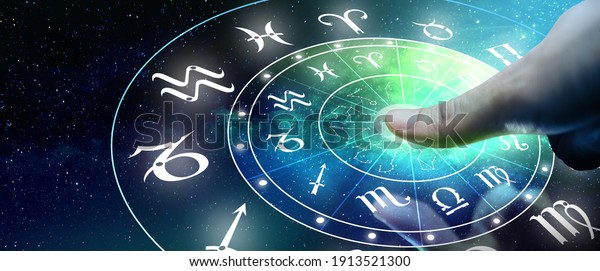 Astrological zodiac signs inside of horoscope\
circle. Man or Woman touching screen Zodiac signs hologram.\
Astrology concept.