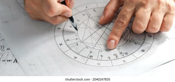 Astrology. Astrologer calculates a natal chart and makes a forecast of fate. Astrological forecast, mysticism, science. Astrological background.