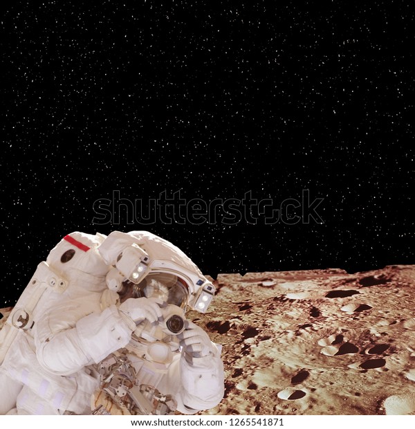 Astronaut with camera and far\
planet. Space mission. The elements of this image furnished by\
NASA.\
