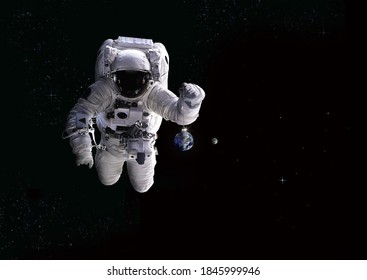 Astronaut And Christmas Ball In Space