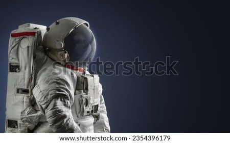 Astronaut in dark space. Spaceman on black background. Elements of this image furnished by NASA
