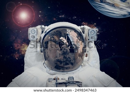 Astronaut and the earth. The elements of this image furnished by NASA.
