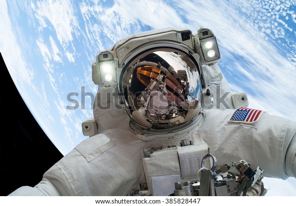 astronaut floating in space with the\
earth in the background\
[some elements courtesy of\
nasa]